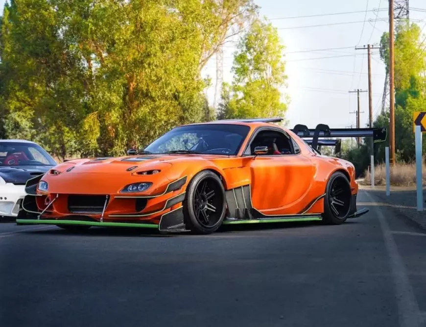 Mazda RX7 modified, finished in orange paint, featured on stance auto magazine