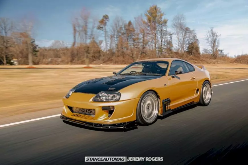 Picture of a Toyota Supra driving down a road shot by stance auto magazine