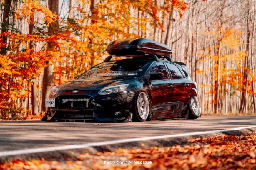 a black ford focus st, lowered parked in the woods in the USA, shot by stance auto magazine