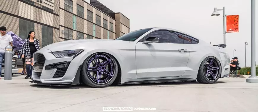 A white Mustang GT slammed on air suspension modified , shot by Stance Auto Magazine