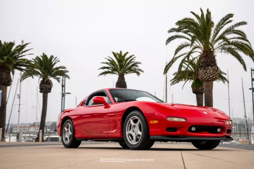 A red 1995 Mazda RX7 FD shot by Stance Auto Magazine Photographers parked at the seaside