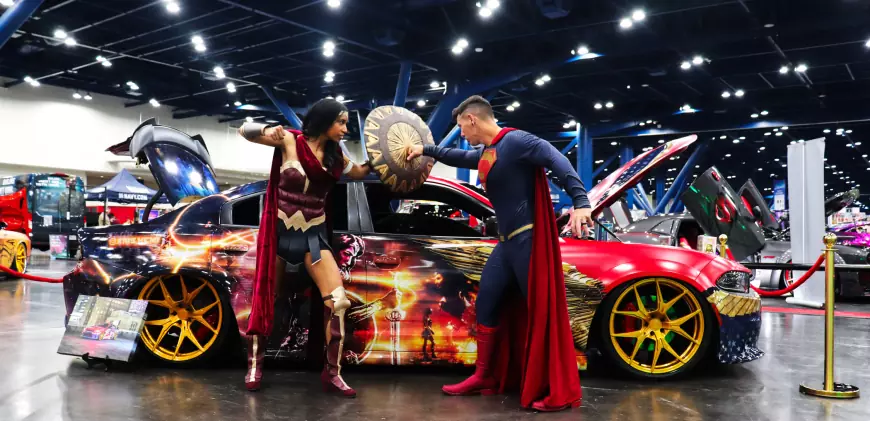 superman and wonder women cosplay at the side of a car