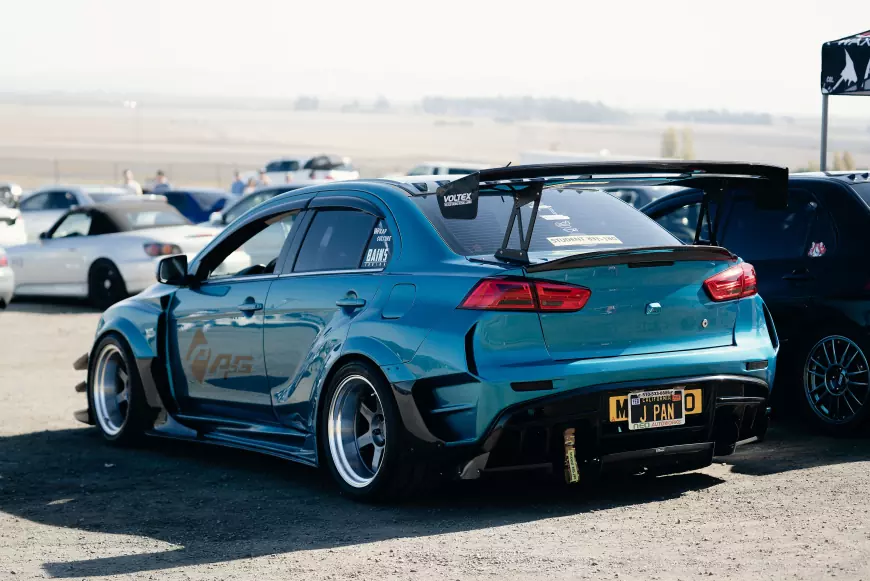 a mitsubishi evo with a varis body kit in blue