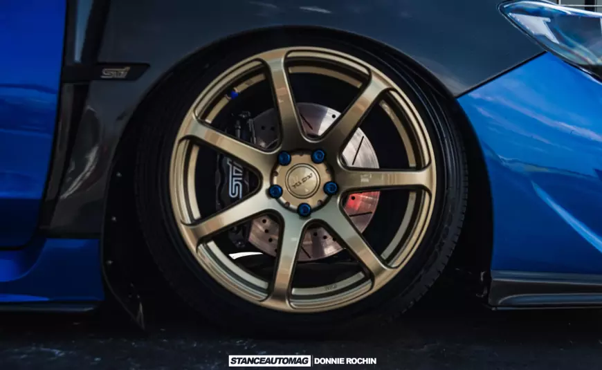 The gold alloy wheels on a Blue 2015 Subaru STI Launch Edition shot by stance auto magazine photographers
