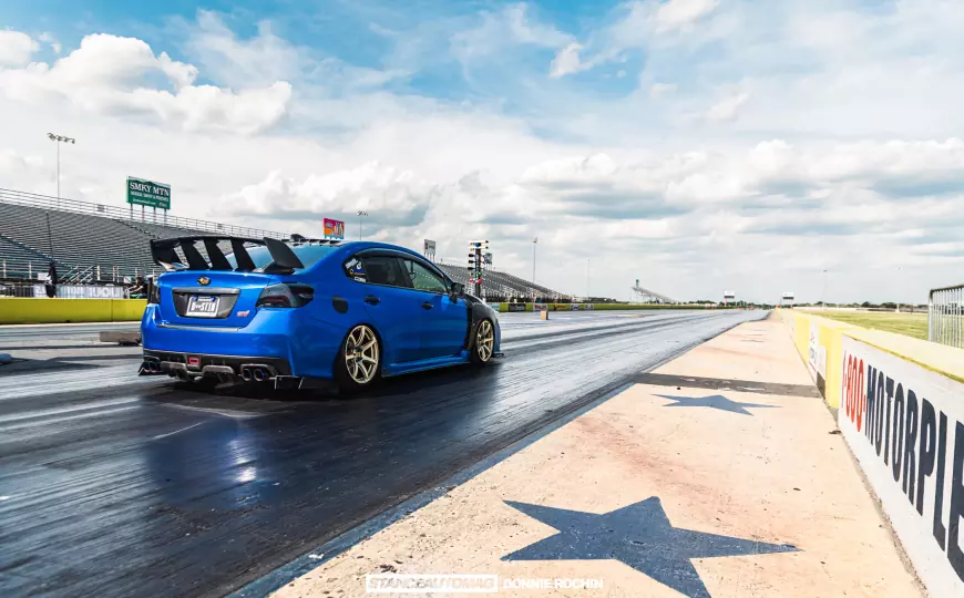a Blue 2015 Subaru STI Launch Edition shot by stance auto magazine photographers on the race track at circuit of the americas