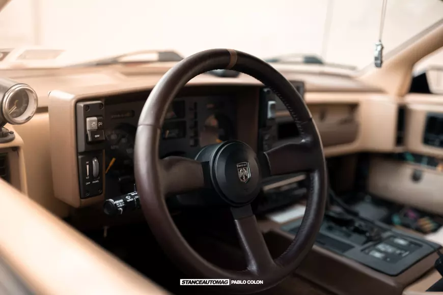 The interior of a 1986 Pontiac Fiero GT shot by stance auto magazine photographers