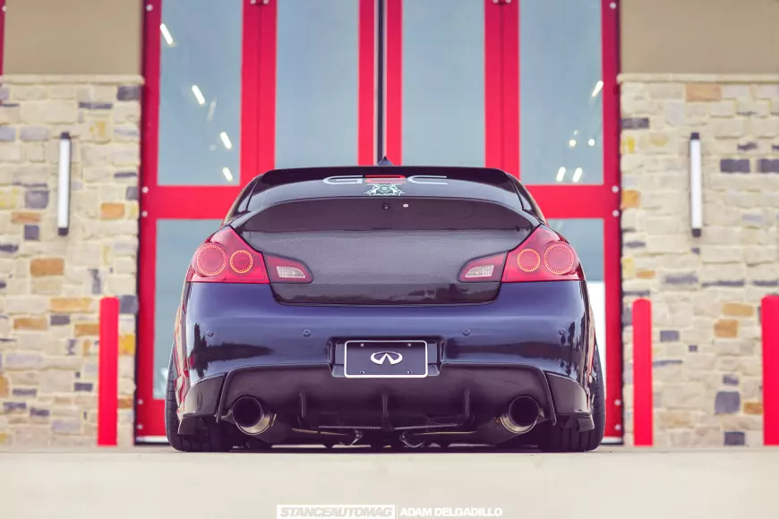 The rear of a 2012 Infiniti G37 showing its exhaust tips
