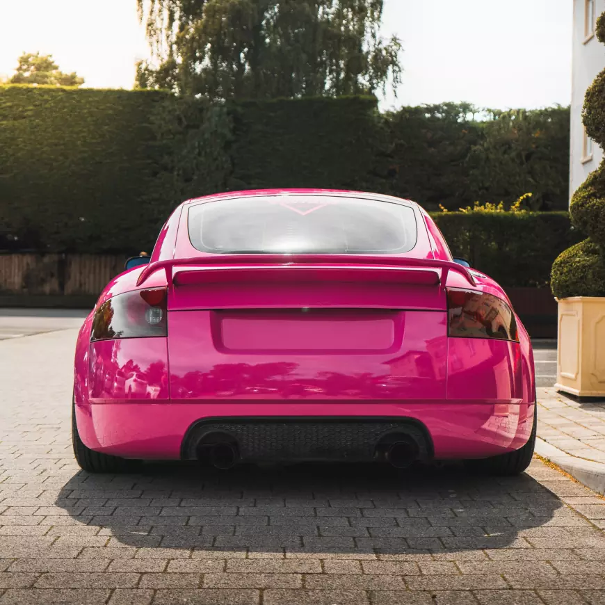 The rear of a Pink 2001 Audi TT with silver wheels 