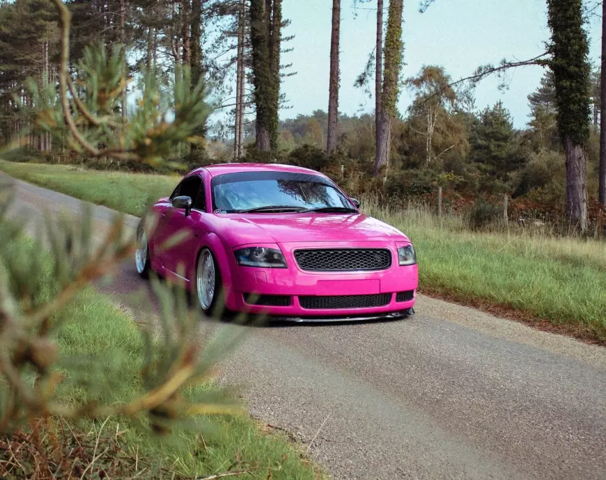 Pink 2001 Audi TT with silver wheels  pictured in the country side