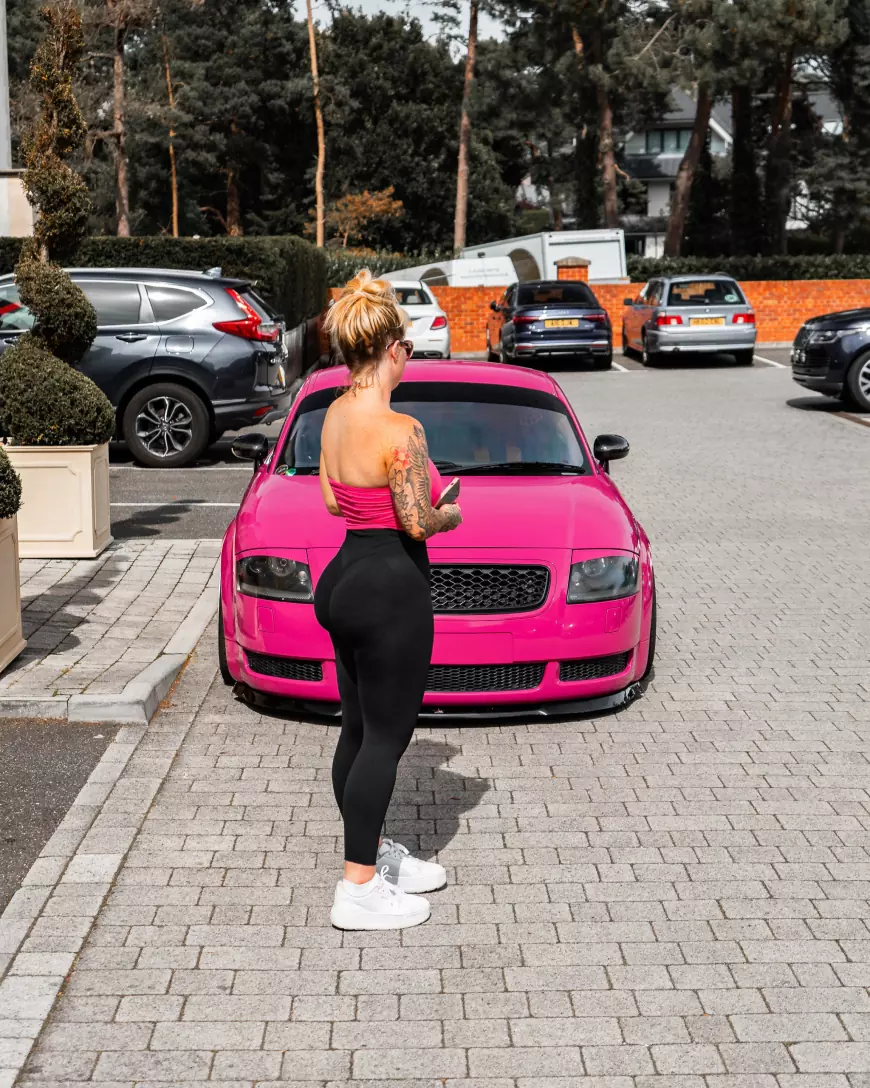 Lauren pictured with her Bagged, Pink 2001 Audi TT with silver wheels 