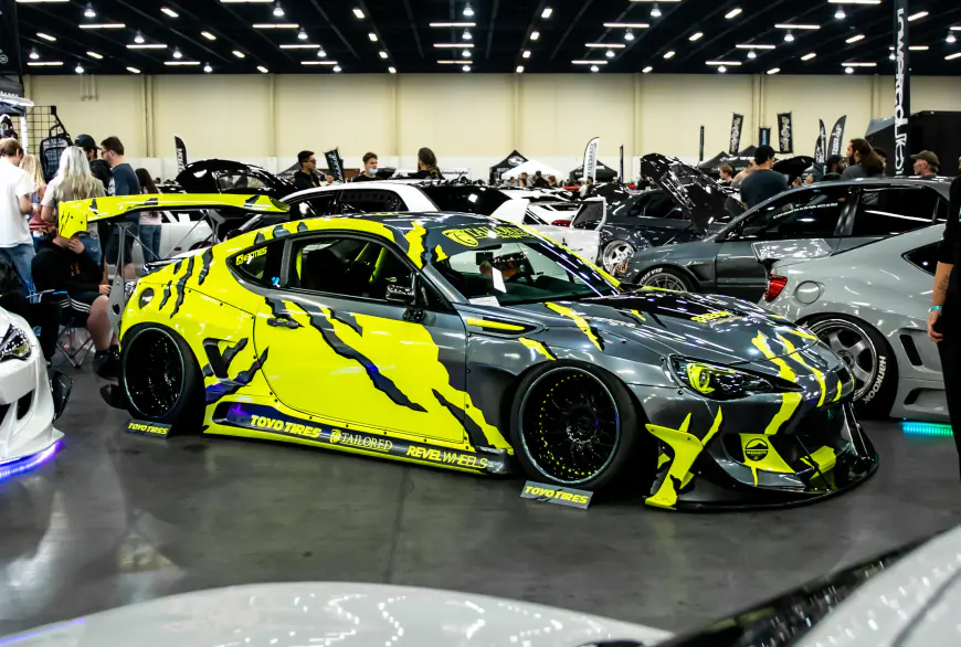 Yellow car partially wrapped on display