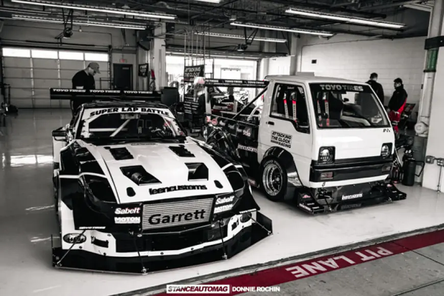 2 race vehicles in a garage at Super Lap Battles