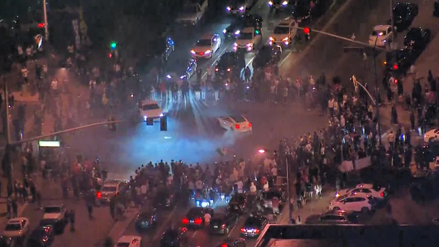 crowds gathering aroung ellegal cars skidding in circles