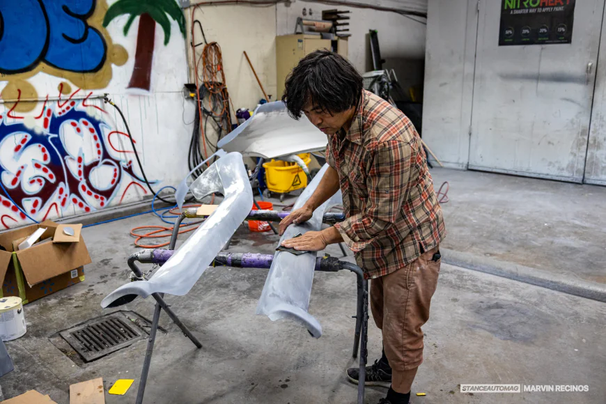 Akira Nakai working on side skirts for a rwb porsche build