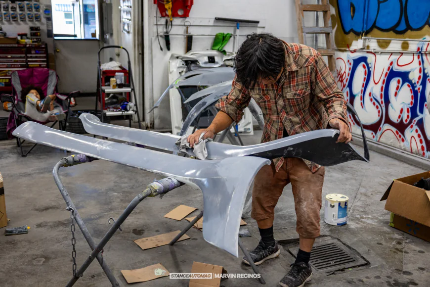 Akira Nakai working on a side skirt