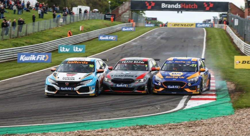 BTCC touring cars racing door to door at Brands Hatch