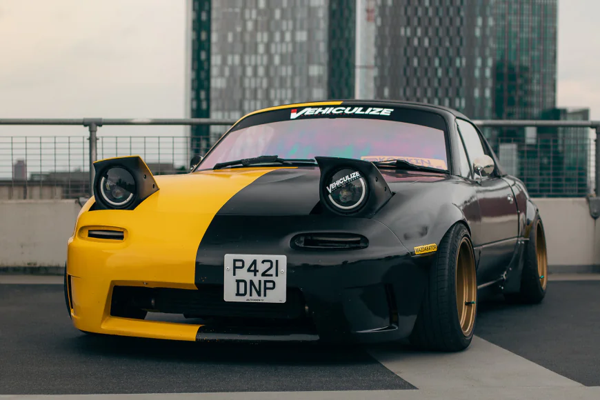 Which car has pop-up headlights and is often referred to as the "Miata"?